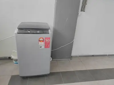 a small white refrigerator sitting in a room at My Homestay Sitiawan - Astronaut Space House 8 Pax in Sitiawan