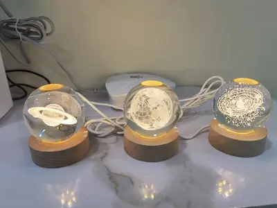 a couple of snow globes on a table with lights at My Homestay Sitiawan - Astronaut Space House 8 Pax in Sitiawan