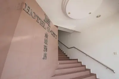 a staircase in a building with a sign on the wall at G CITY HOTEL in Teluk Intan