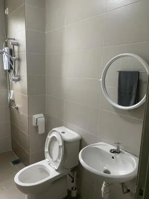 a bathroom with a toilet and a sink and a mirror at New GoldenHill Condo 3BR 1Min Pasar Mlm Cameron Highlands in Tanah Rata