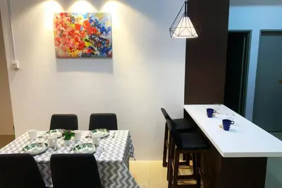 a table with chairs and a painting on the wall at New GoldenHill Condo 3BR 1Min Pasar Mlm Cameron Highlands in Tanah Rata