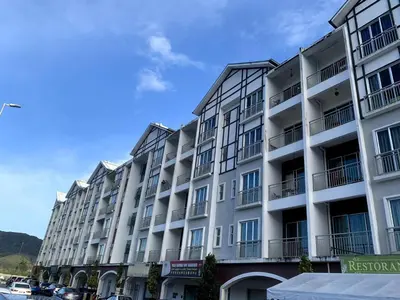 a large white building with balconies on a street at New GoldenHill Condo 3BR 1Min Pasar Mlm Cameron Highlands in Tanah Rata