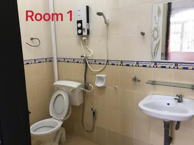 a bathroom with a toilet and a sink at 66 Semi-D Homestay in Teluk Intan