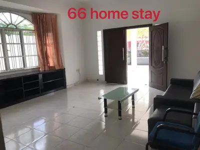 a living room with a coffee table and a door at 66 Semi-D Homestay in Teluk Intan