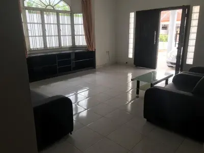 a living room with two couches and a glass table at 66 Semi-D Homestay in Teluk Intan