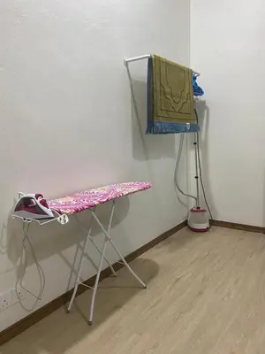 a table and a chair in a room at Ainaz Homestay Balik Pulau in Balik Pulau