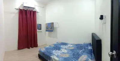 a bedroom with a bed and a red curtain at Ainaz Homestay Balik Pulau in Balik Pulau