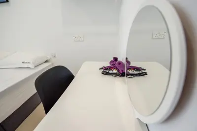 a room with a table with a mirror and a bed at De Luma Alma 9 bedroom with 8 bathroom in Bukit Mertajam