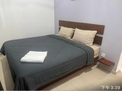 a bed with two white towels on top of it at Pangkor L30 88 Corner villa House in Pangkor