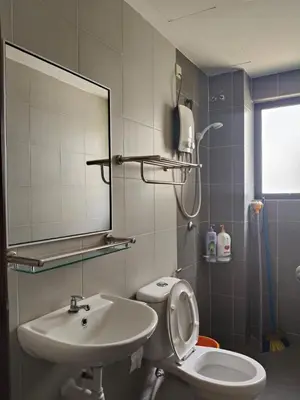 a bathroom with a sink and a toilet and a mirror at Pangkor L30 88 Corner villa House in Pangkor