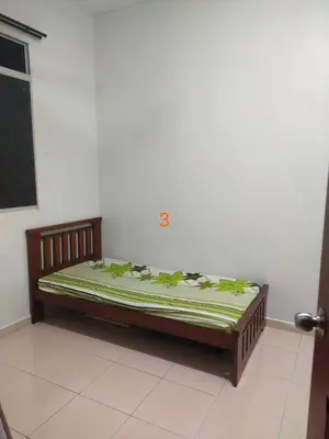 a bed sitting in a corner of a room at Rumah Singgah in Pantai Remis