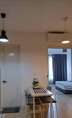 a living room with a table and a bed at Woodsbury Suites IKEA House Butterworth Penang in Butterworth