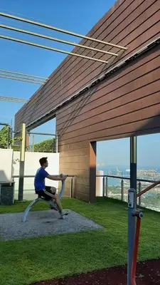 a man swinging a baseball bat in front of a building at Woodsbury Suites IKEA House Butterworth Penang in Butterworth