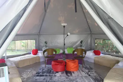 a tent with a group of chairs and tables at Fraser Valley Kuala Kubu Bharu in Kuala Kubu Baharu
