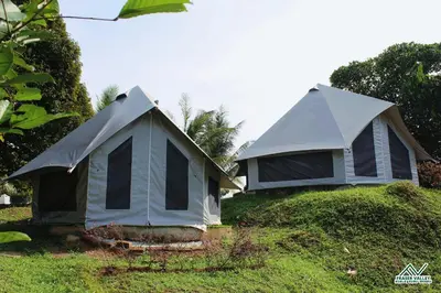 two tents sitting on top of a grass field at Fraser Valley Kuala Kubu Bharu in Kuala Kubu Baharu
