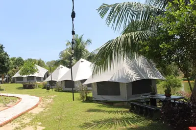 a row of tents in a yard with grass and trees at Fraser Valley Kuala Kubu Bharu in Kuala Kubu Baharu