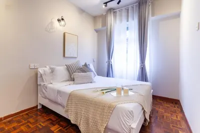 a white bedroom with a bed and a window at Star Regency by Plush in Brinchang