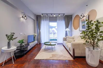 a living room with a couch and a table at Star Regency by Plush in Brinchang