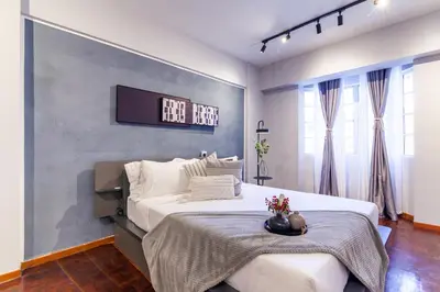 a bedroom with a bed and a tv on the wall at Star Regency by Plush in Brinchang