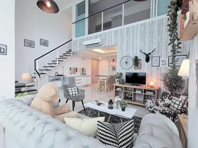 a living room with a white couch and a table at Maritime Suites Penang in Jelutong