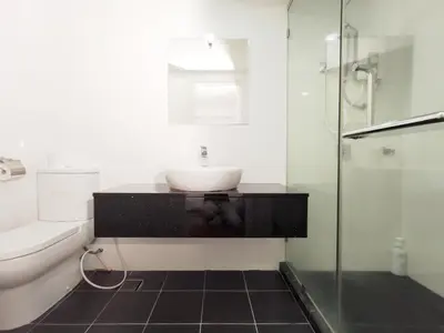 a bathroom with a sink and a glass shower at Maritime Suites Penang in Jelutong