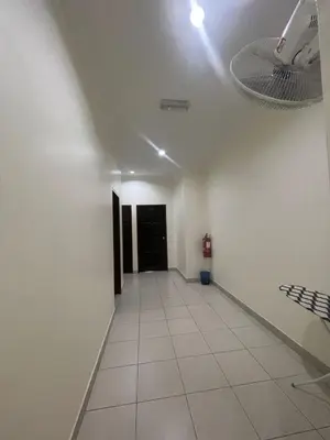 a hallway with a room with a ceiling fan at Intanova Hotel in Teluk Intan