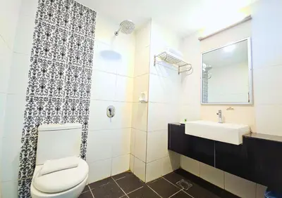 a bathroom with a toilet and a sink at Hotel Taiping Perdana in Taiping