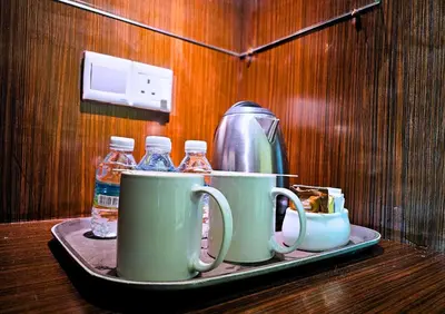 a tray with cups and bottles of water on a table at Hotel Taiping Perdana in Taiping