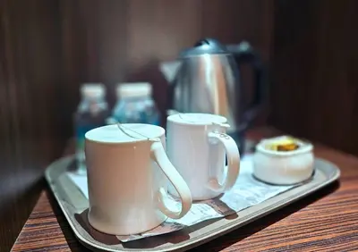 a tray with two coffee cups and a tea pot at Hotel Taiping Perdana in Taiping