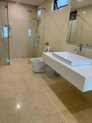 a bathroom with a sink and a toilet and a shower at Jazz Service Suites 2 bedroom 35-1 by Yen's Sojourn in Bagan Jermal