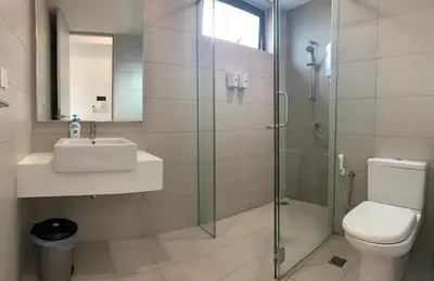 a bathroom with a shower and a sink and a toilet at Jazz Service Suites 2 bedroom 35-1 by Yen's Sojourn in Bagan Jermal