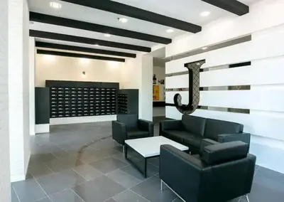 a waiting room with a couch and a table at Jazz Service Suites 2 Bedroom 23-3 by Yen's Sojourn in Bagan Jermal