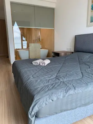 a bedroom with a bed with two towels on it at Jazz Service Suites 2 Bedroom 23-3 by Yen's Sojourn in Bagan Jermal