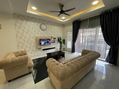 a living room with two couches and a tv at De’ Nuhir Homestay Teluk Senangin in Kampong Batu Tiga