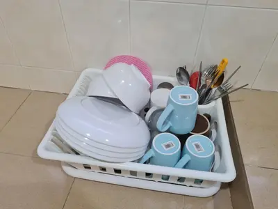 a dish rack filled with dishes and utensils at Air-home No135 Kampung Boyan, 3BR, 6pax Netflix in Taiping