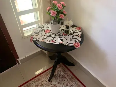 a round table with flowers on top of it at Damai Homestay in Kampong Jabi