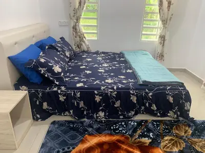 a bedroom with two beds with blue sheets at Damai Homestay in Kampong Jabi