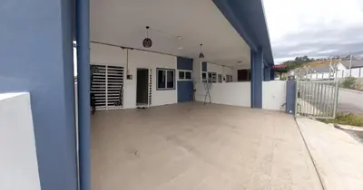 a large empty porch of a building with blue columns at Homestay D'Mama Īfor mūslimĪ in Tanjung Malim