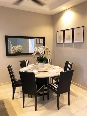 a dining room with a table and eight chairs at SB PRIMA VILLA APRTMENT in Tanah Rata