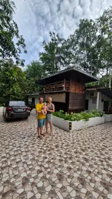 two boys standing in front of a house at Hometostay Bokbak Kupang in Kampong Baubak