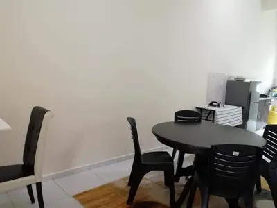 a black table and chairs in a room at Homestay Dorani Sungai Besar in Sungai Besar