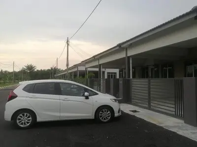 a white car parked in front of a building at Homestay Dorani Sungai Besar in Sungai Besar