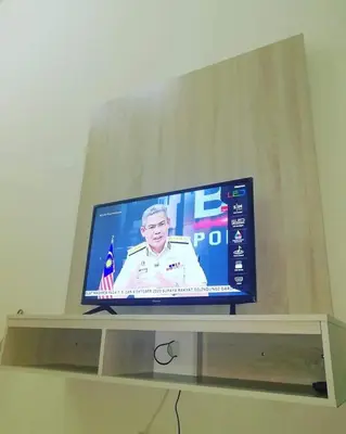 a flat screen tv sitting on top of a shelf at Homestay Dorani Sungai Besar in Sungai Besar