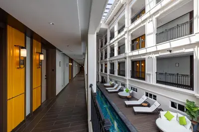 a corridor of an apartment building with couches and tables at The George Penang by The Crest Collection in George Town