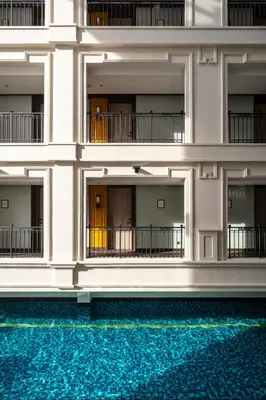 a building with blue water in front of it at The George Penang by The Crest Collection in George Town