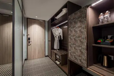 a dressing room with a robe hanging on a closet at The George Penang by The Crest Collection in George Town