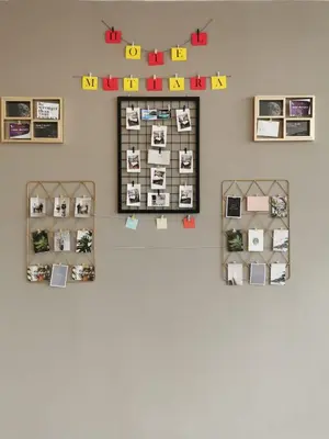 a wall with a mirror and pictures on it at Hotel Mutiara in Gua Musang