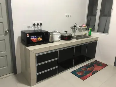 a kitchen counter with a sink and a microwave at Venus Hollywood Homestay Sitiawan in Seri Manjung