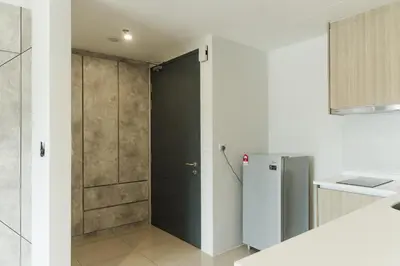 a kitchen with a black door and a refrigerator at The Palm, 2BR Cityview by WStay @ Tropicana 218 Macalister in George Town