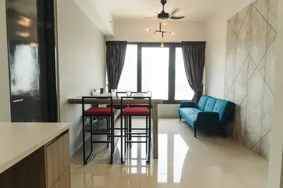 a kitchen with a bar with stools and a blue couch at The Palm, 2BR Cityview by WStay @ Tropicana 218 Macalister in George Town